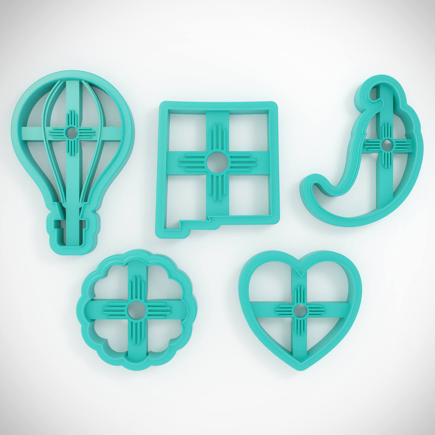 Set of five turquoise cookie cutters on a light gray background